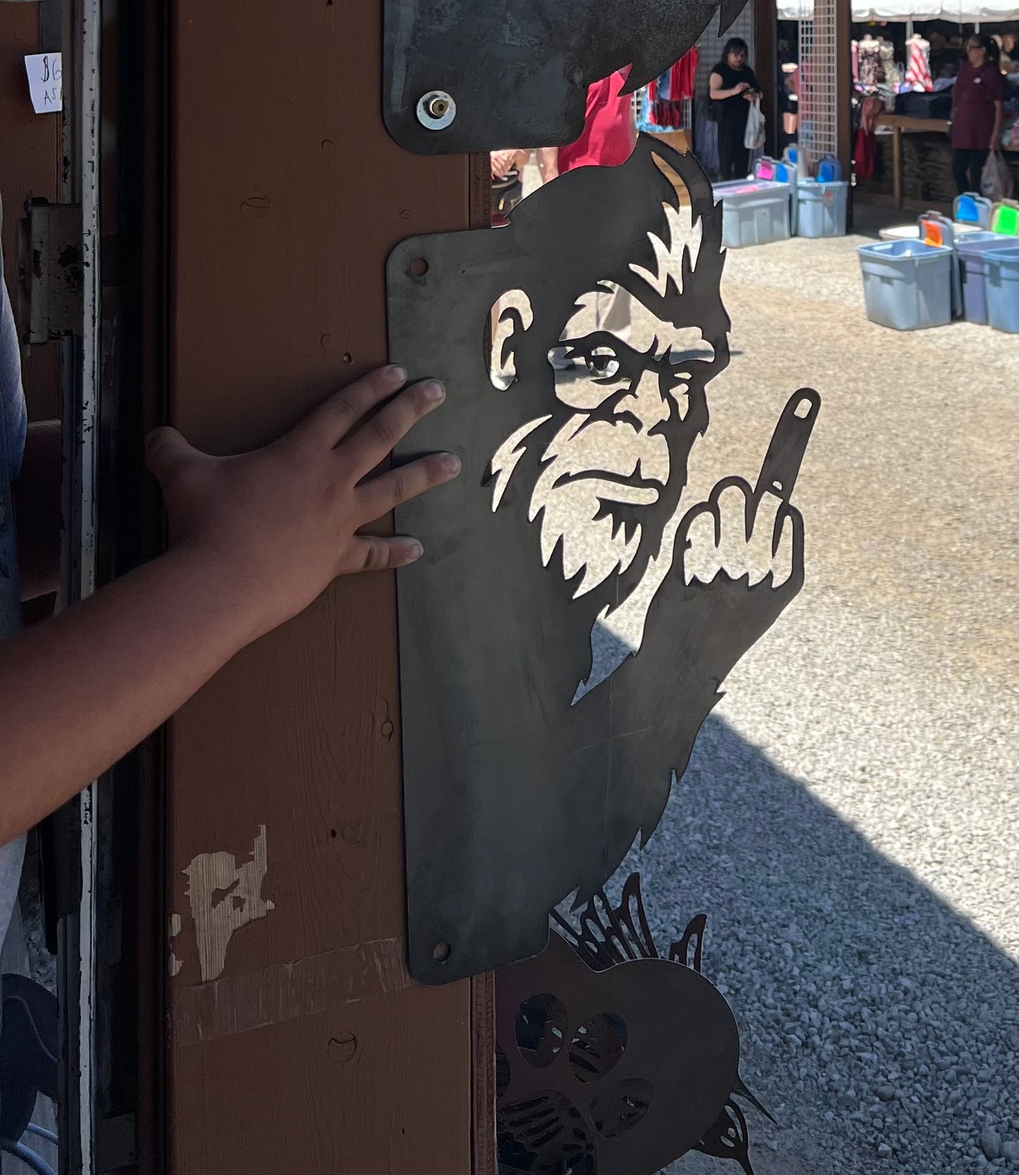 Peak a boo middle finger big foot fence hanger